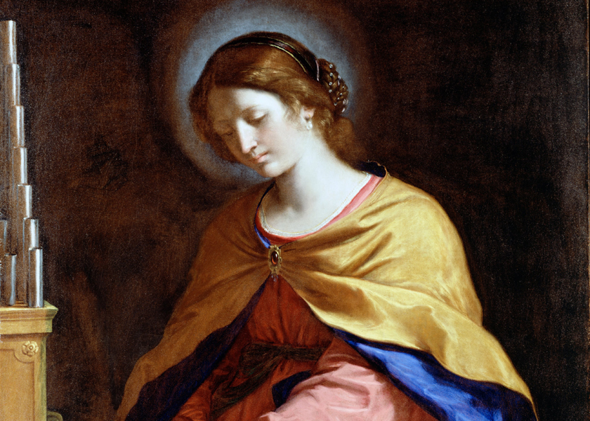 Baroque period painting of St. Cecelia by Guercino from 1649. There is a visible halo of light around her head, and she is playing the organ.